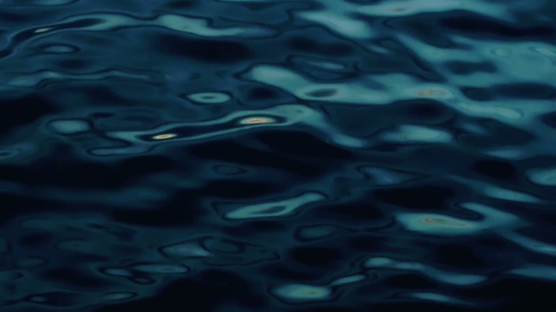 Slow moving deep blue water at dusk